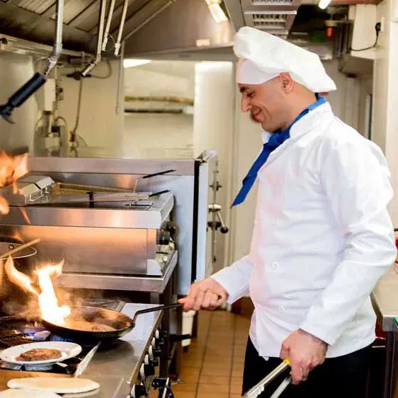 Sycamore Ridge Chef Created Meals, chef frying a dish.