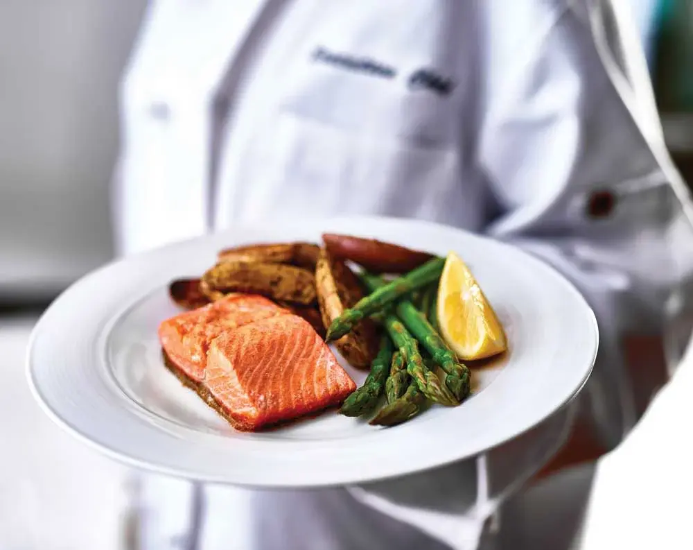 Sycamore Ridge Chef Created Meals, chef delivering a finished dish.